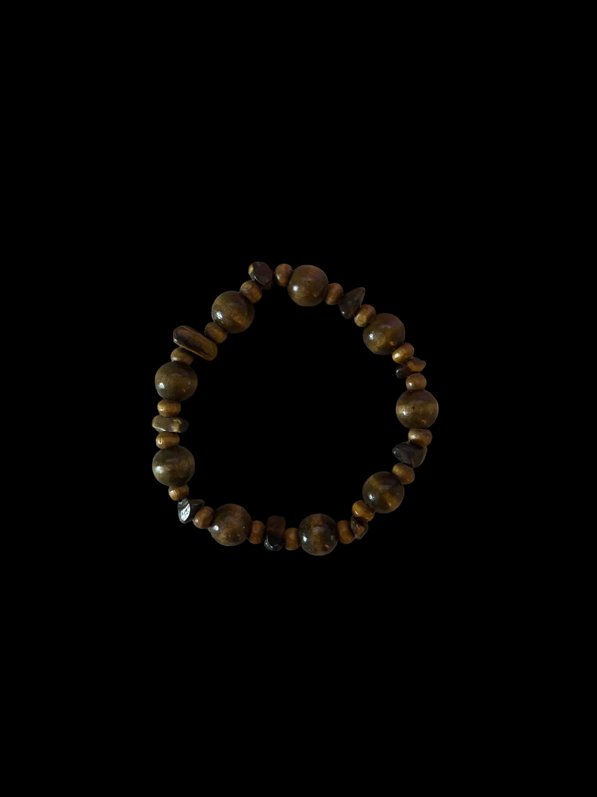 A beaded stretch bracelet made of polished brown and gold-toned gemstone beads, displayed on a plain off-white surface.